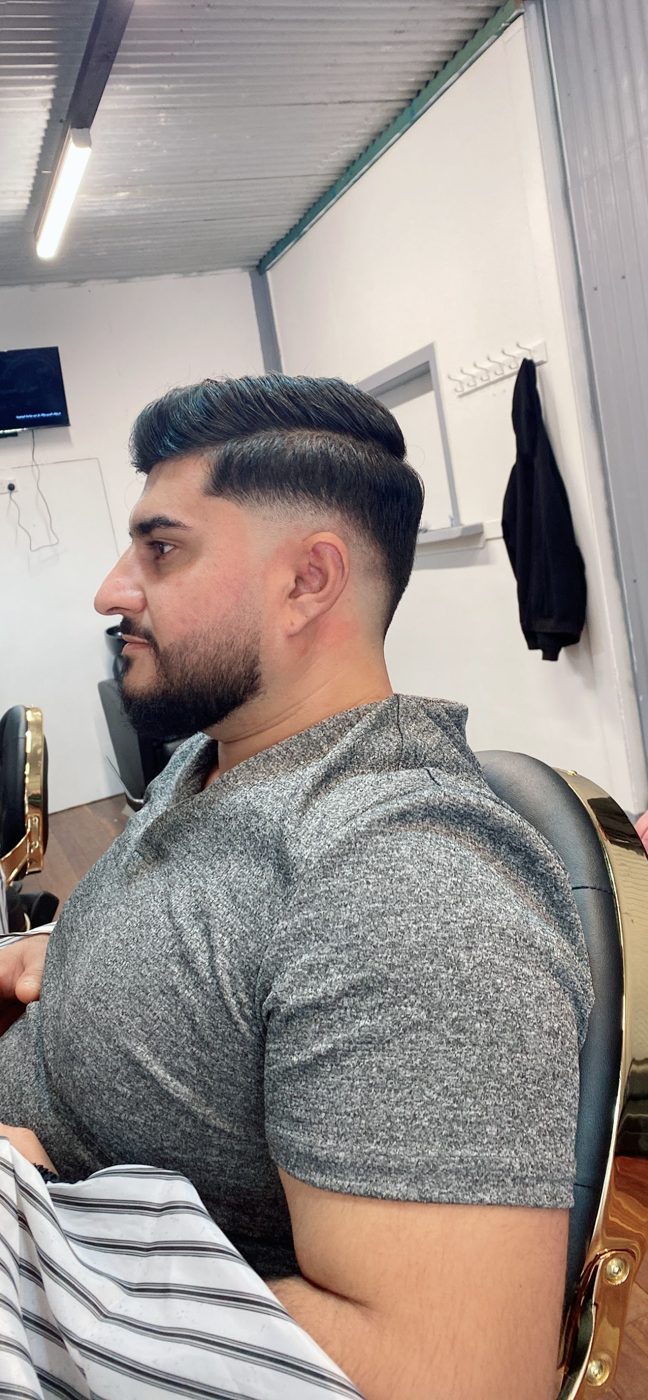 Pompadour with a skin fade and full beard, cut at Stars Barber Shop